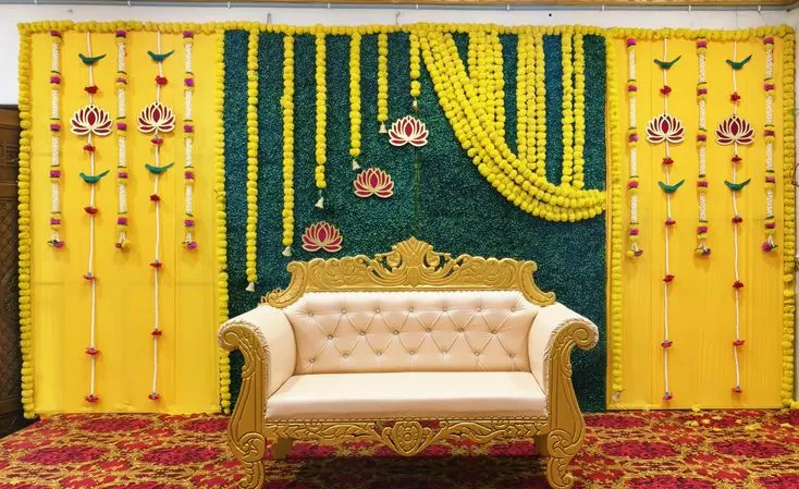 Yellow and green floral stage with lotus motifs and a central sofa